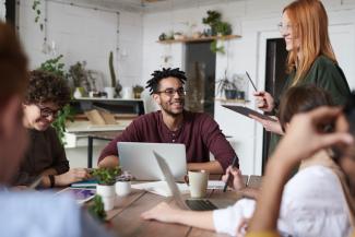 Group of young professionals in a meeting. They are in a casual office setting